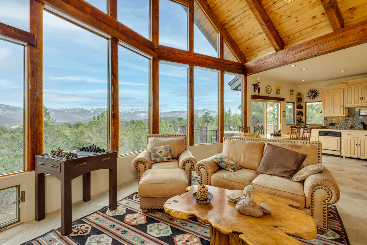 499 Waterview Lane Ridgway, CO 81432 - Photo 8 of 43 a living room with furniture and a floor to ceiling window