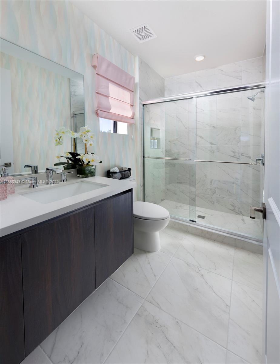 8259 Southwest 120th Terrace Miami, FL 33156 - Photo 19 of 25 a bathroom with a double vanity sink toilet and shower