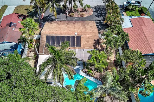 an aerial view of a house with a yard and garden