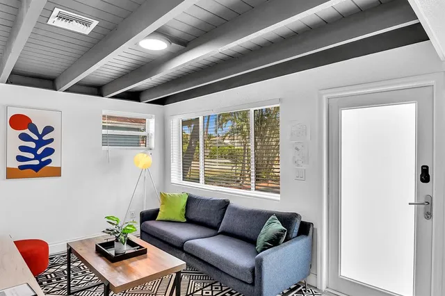 a room with furniture pool table and windows