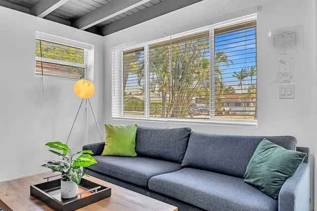 a living room with furniture and a book shelf