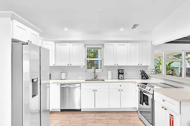 a view of a backyard with plants and a patio