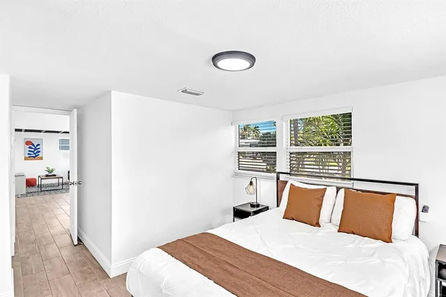 a living room with stainless steel appliances kitchen island granite countertop furniture and a flat screen tv