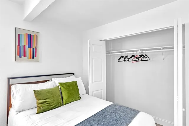 a view of a patio with table and chairs and floor to ceiling window