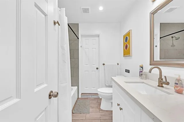 a view of a white house with a swimming pool lawn chairs and a fire pit