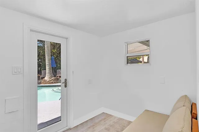 an aerial view of residential houses with outdoor space and trees all around