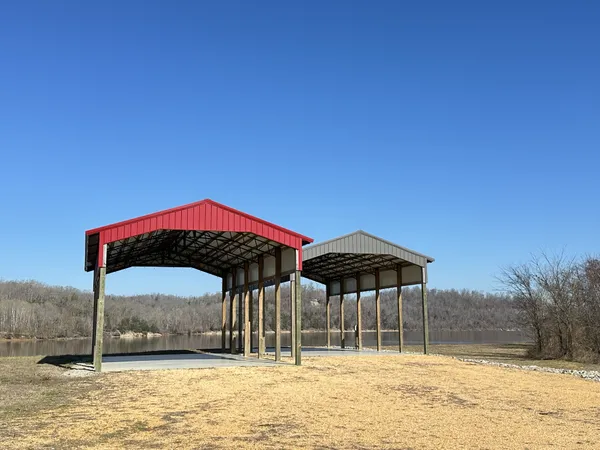 a view of a dirt road with a building in the background