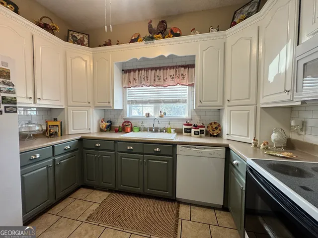 a kitchen with a sink stove and cabinets