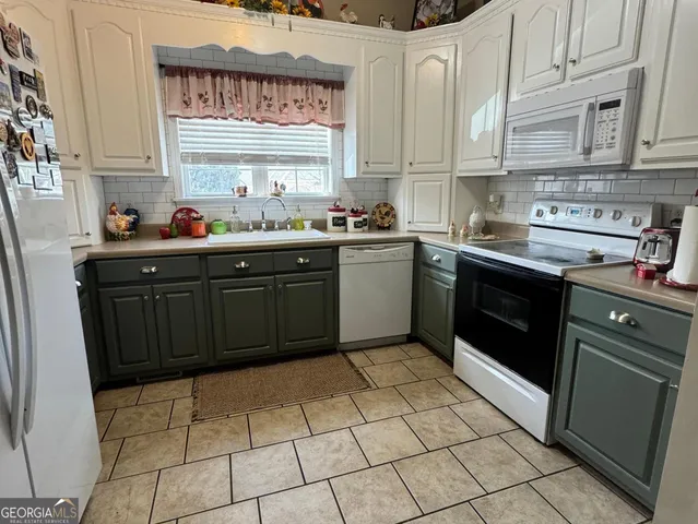 a kitchen with a stove sink and cabinets