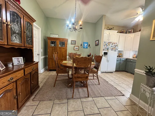 a view of a dining room with furniture and chandelier