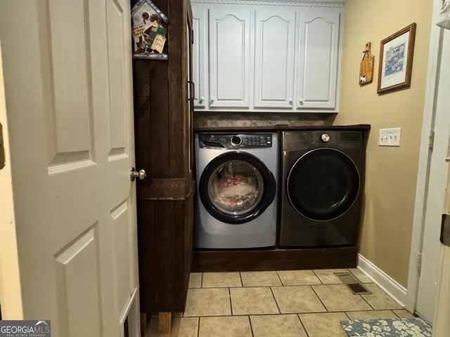 a utility room with mirror dryer and washer