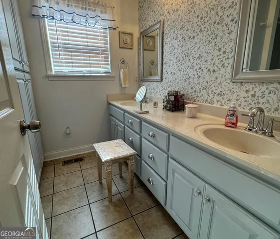a bathroom with a toilet a sink and a mirror