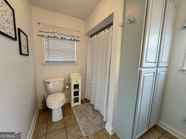a bedroom with furniture and a book shelf