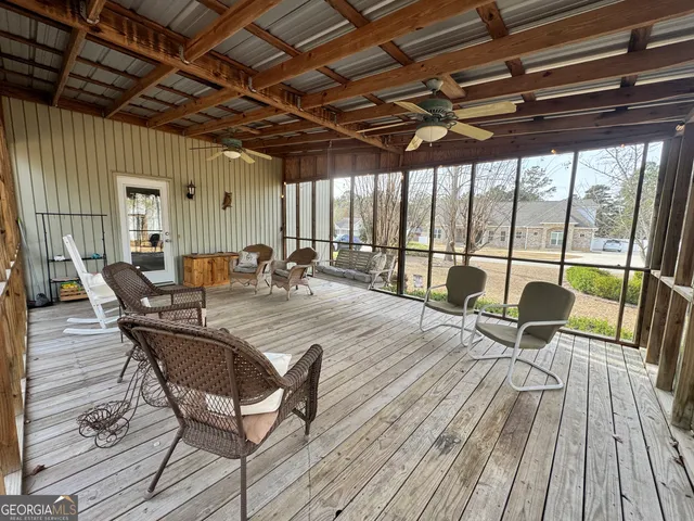 a view of a patio with table and chairs