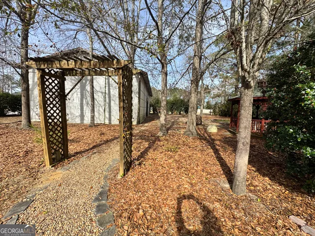 a view of outdoor space with deck and trees