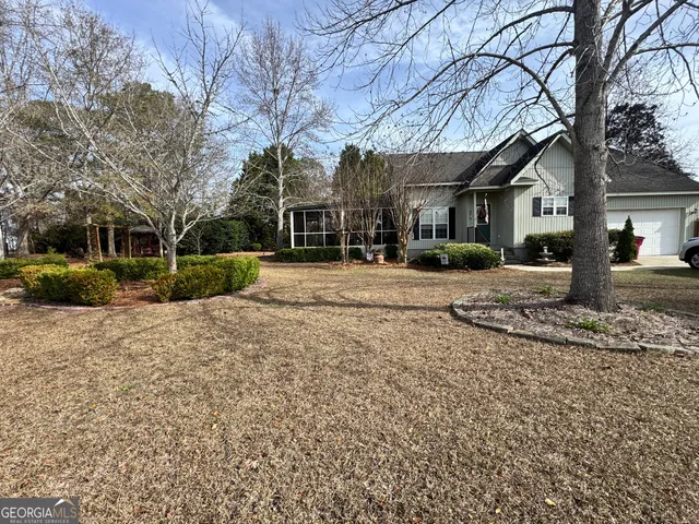 a view of a road with a house in the background