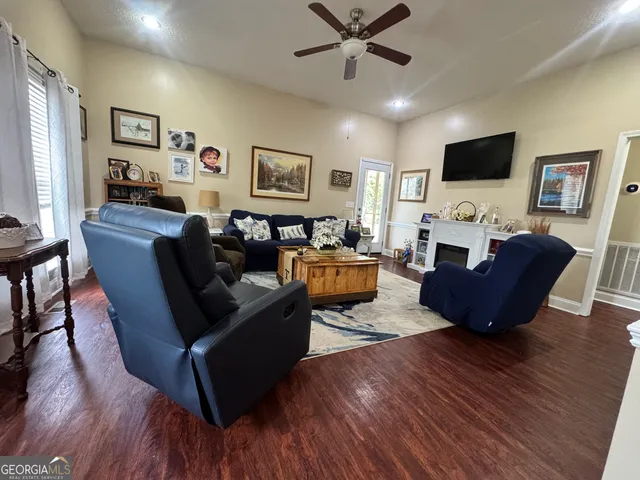 a living room with furniture and a flat screen tv
