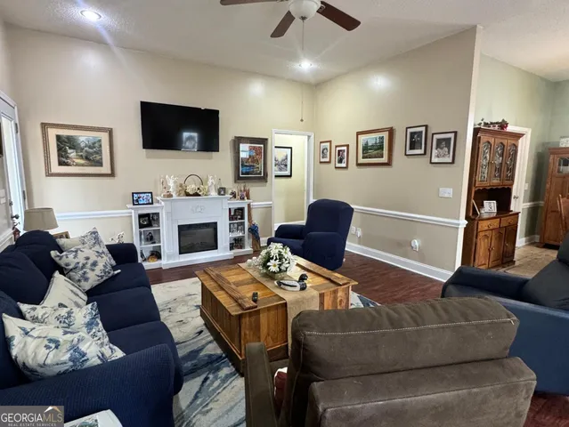 a living room with furniture flat screen tv and a fireplace