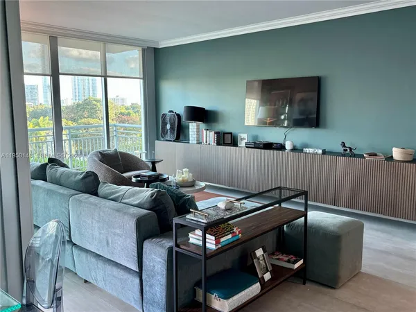 a bedroom with a large bed and a potted plant