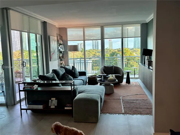 a bedroom with a bed and large windows