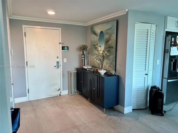 a living room with furniture a rug and a floor to ceiling window