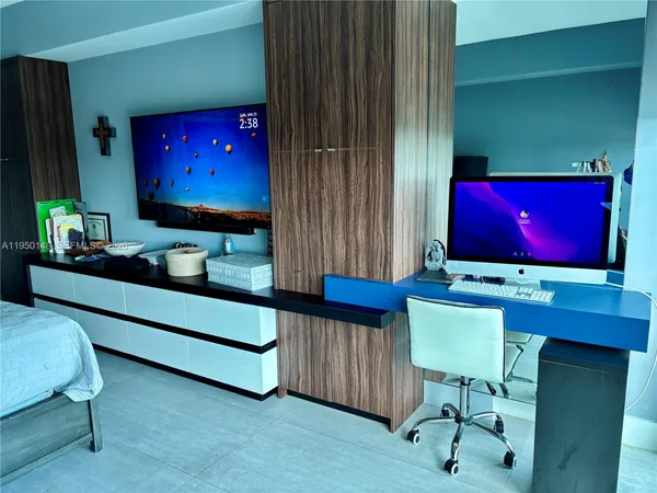 a bathroom with a granite countertop sink mirror vanity and toilet
