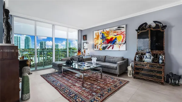 a bedroom with furniture and a large window