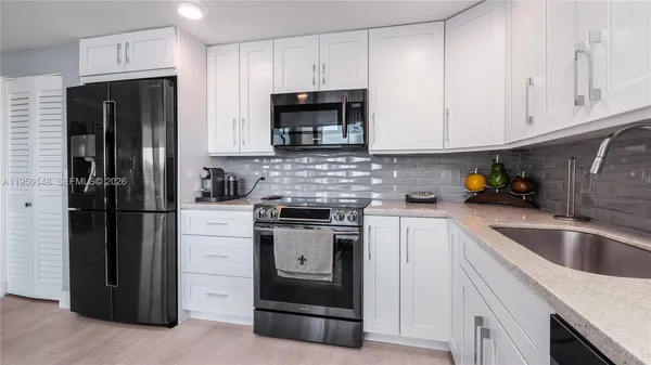 a living room with furniture and floor to ceiling windows