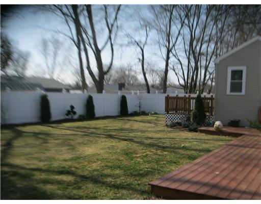 66 Glenbrook Road Warwick, RI 02889 - Photo 3 of 18 Exterior Back. Private back yard is lovingly landscaped & outlined with a quality vinyl fence.