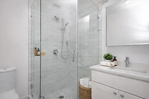 a bathroom with a sink toilet and shower
