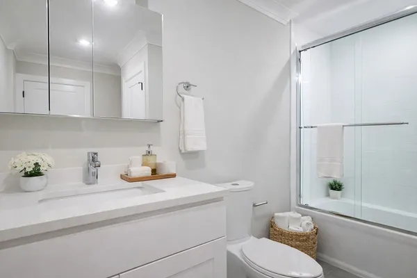 a bathroom with a sink toilet and shower