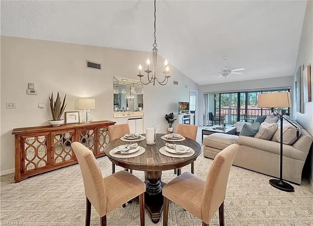 905 Augusta Boulevard Naples, FL 34113 - Photo 9 of 20 a view of a dining room with furniture and chandelier