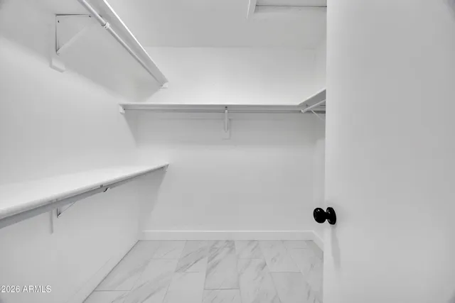 a bathroom with a double vanity sink a toilet and a mirror