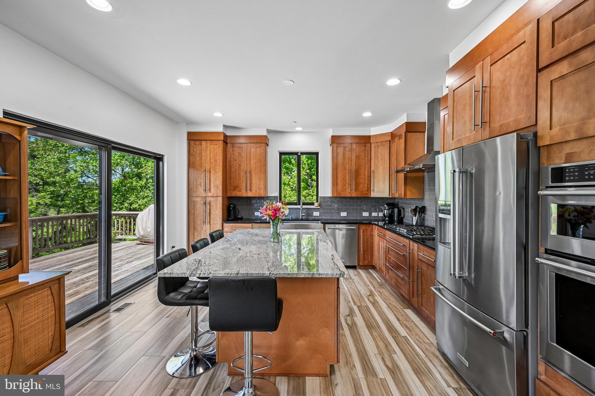 11 Forklanding Road Cinnaminson, NJ 08077 - Photo 12 of 77 a kitchen with stainless steel appliances granite countertop a refrigerator a sink dishwasher a stove and a dining table with wooden floor
