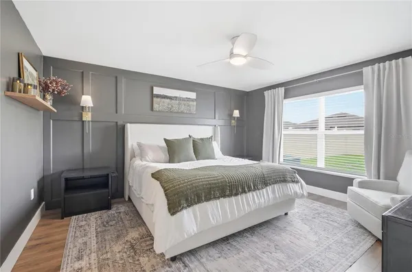 a bedroom with a large bed and a couch