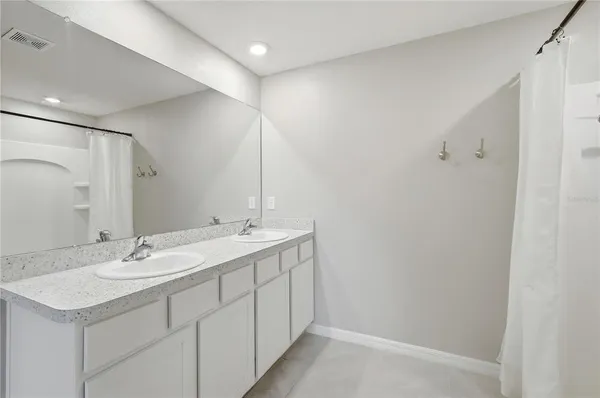 a bathroom with a sink double vanity and a mirror