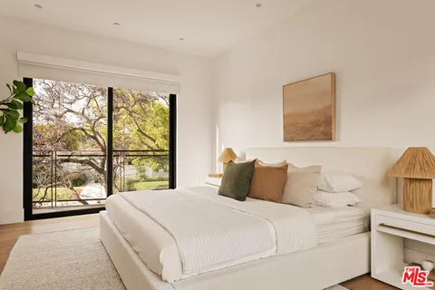 a bedroom with a large bed and a large window