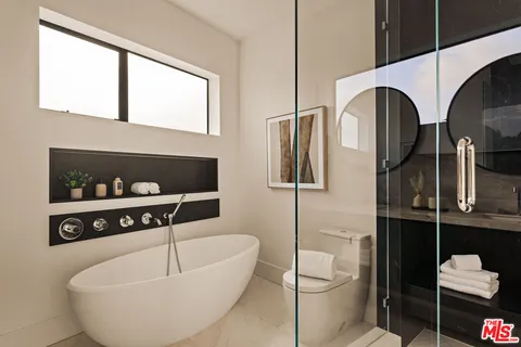 a bathroom with a toilet a sink and bathtub