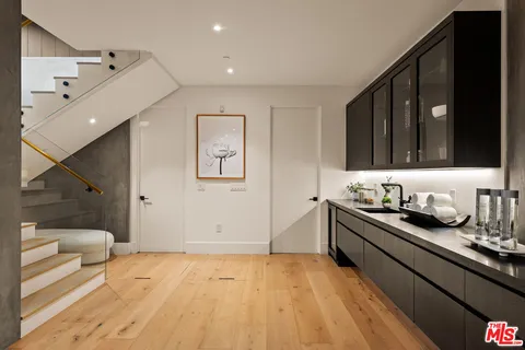 a kitchen with granite countertop a stove and a wooden cabinets
