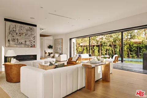 a living room with kitchen island furniture and a large window