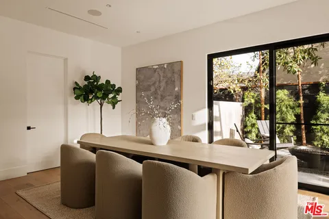 a dining room with a large window and table