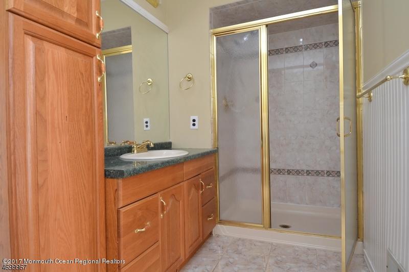 5 D Brookside Heights, Unit 102 Wanaque, NJ 07465 - Photo 11 of 15 a bathroom with a shower sink and mirror