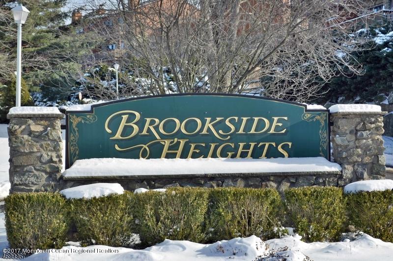 5 D Brookside Heights, Unit 102 Wanaque, NJ 07465 - Photo 3 of 15 a sign that is sitting on a brick wall