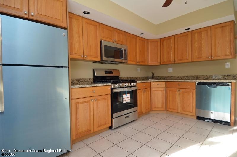 5 D Brookside Heights, Unit 102 Wanaque, NJ 07465 - Photo 5 of 15 a kitchen with a sink a stove and refrigerator