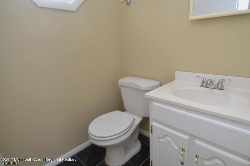 5 D Brookside Heights, Unit 102 Wanaque, NJ 07465 - Photo 9 of 15 a white toilet sitting next to a white sink