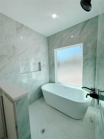 a bathroom with a bathtub and shower