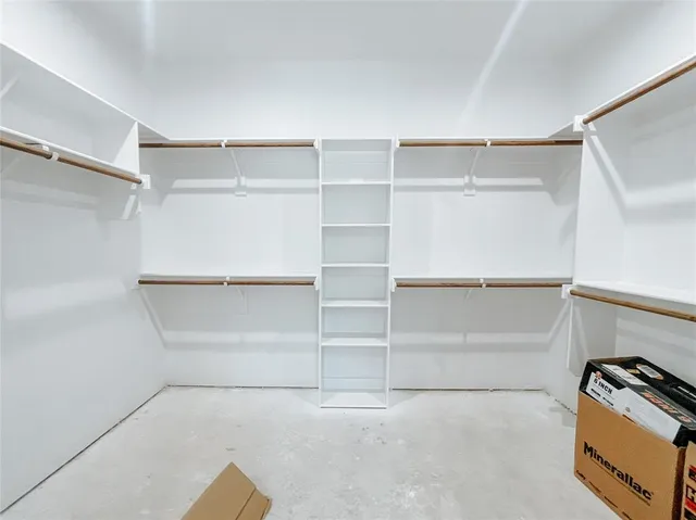 a view of walk in closet with empty racks
