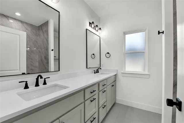 a bathroom with a double vanity sink mirror and