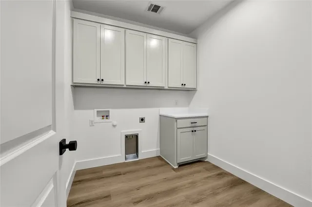 a view of an empty room with closet and a window