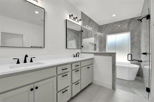 a spacious bathroom with a double vanity sink mirror and toilet